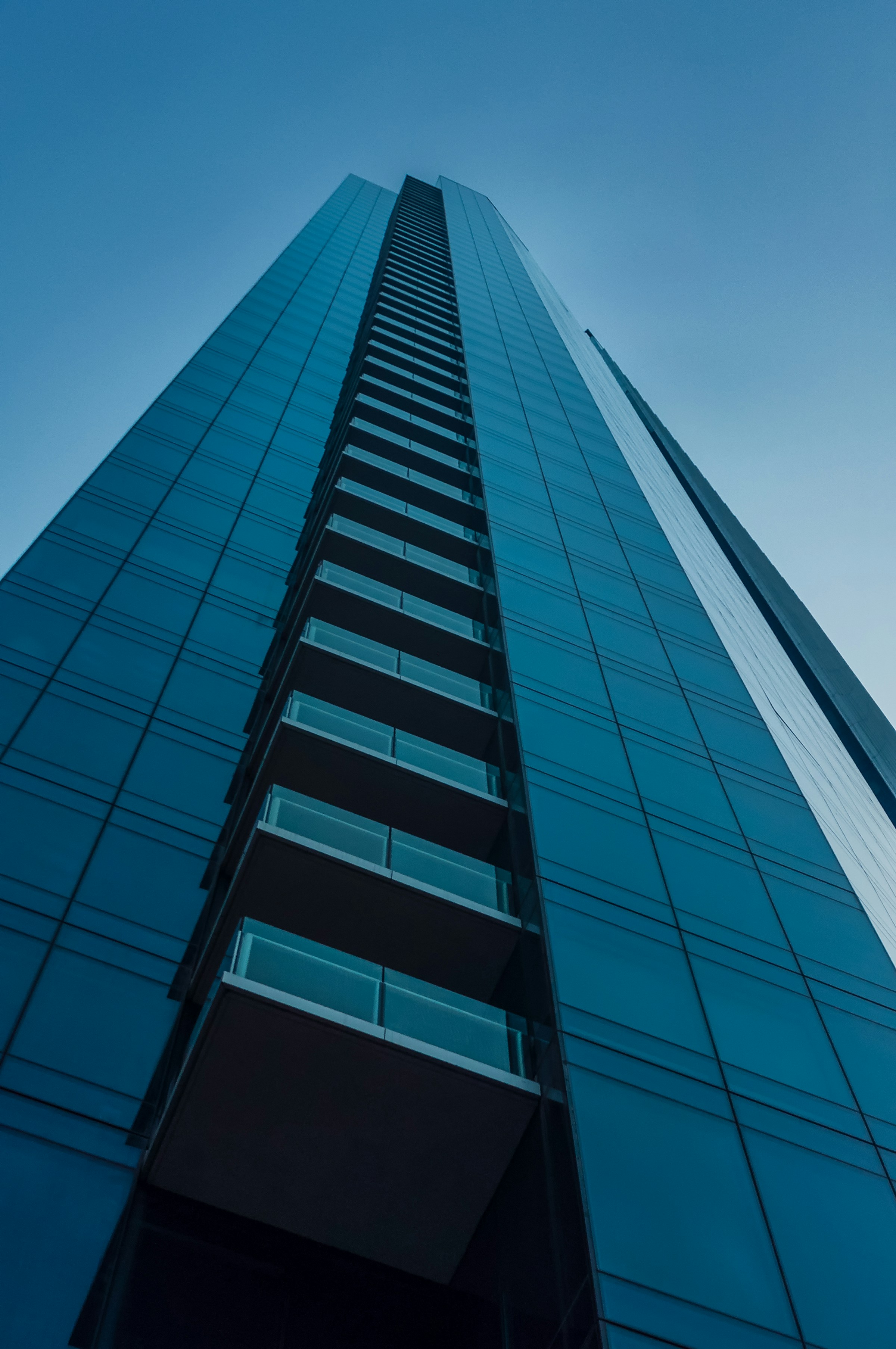 Contemporary glass office tower viewed from below